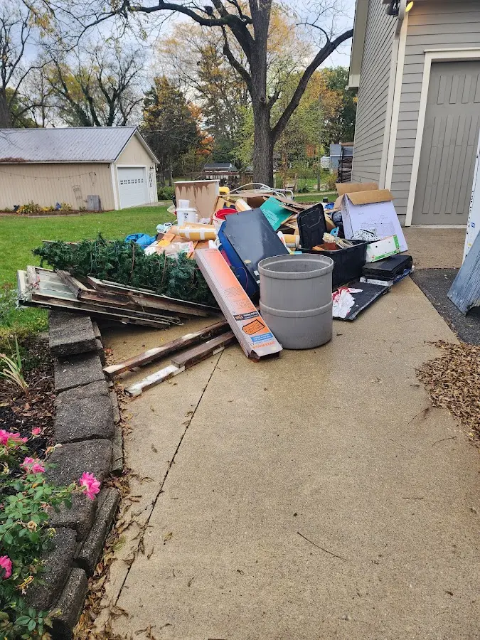 Dumpster being loaded with debris for 12 Yard Dumpster Rental in Cutler